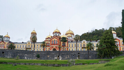 Fototapeta na wymiar Panoramic view of orthodox monastery in Novy Afon, Abkhazia. Ensemble of christian churches in New Athos. One of the most popular tourist destination at black sea coast of the Caucasus