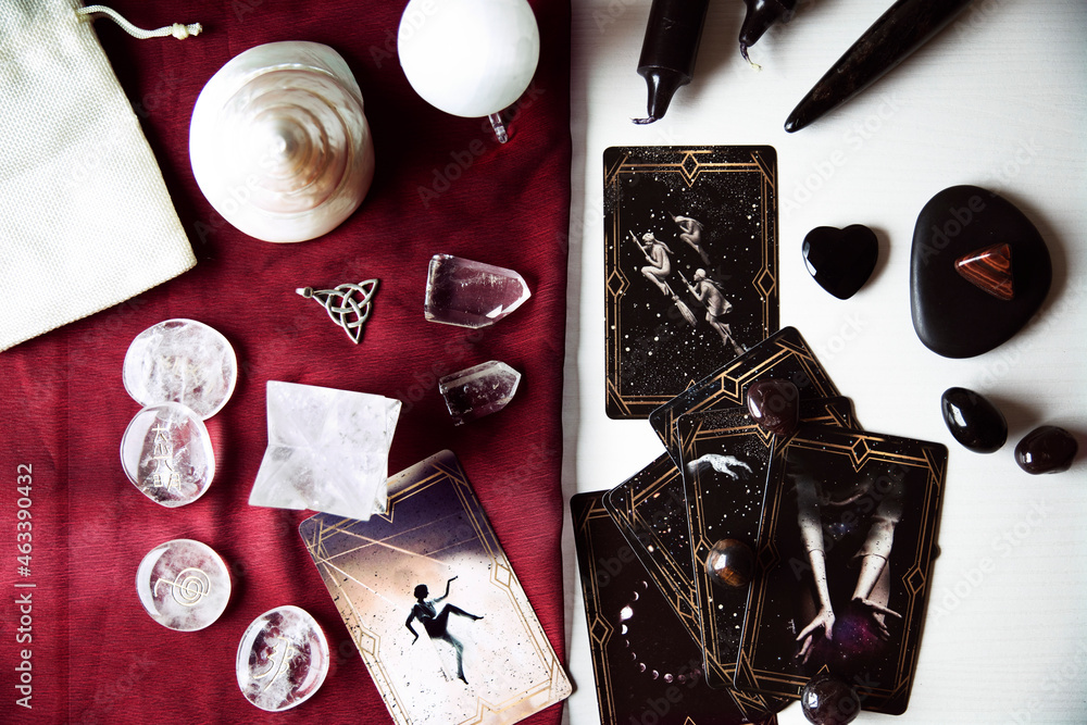 Wall mural altar with tarot cards on a burgundy scarf with several white quartz crystals, runes, black candles 