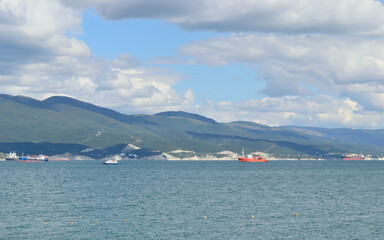  sea pieceseascape with mountains and cumulus low clouds over water, background