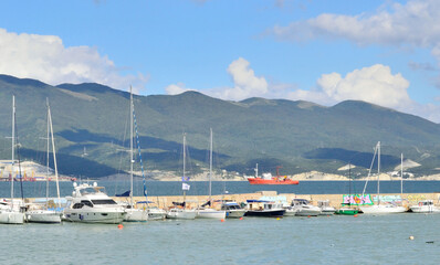 Fototapeta na wymiar many yachts are moored on the sea bay, prepared for a sailing trip