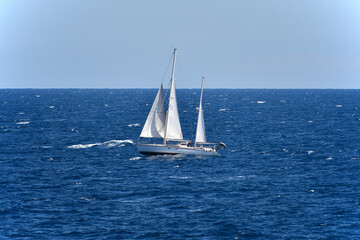 Fototapeta premium Beautiful white sailboat sailing in the Mediterranean near Corsica.