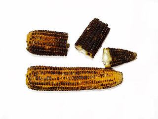 Organic roasted sweet corn on the cob isolated on white background.