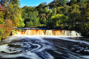 Wain Wath Force Waterfall on a sunny Autumn Day, Yorkshire Dales National Park, England, UK.