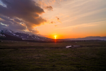 Sunset grassland beauty, The warm light shines on the mountains and meadows