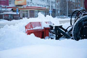Snowblower cleans sidewalks. Russian Winter. Workers remove snow from the sidewalks. Russian Winter. Snow removal.