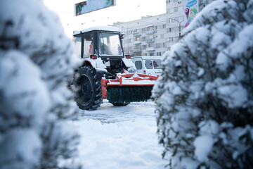 Snowblower cleans sidewalks. Russian Winter. Workers remove snow from the sidewalks. Russian...