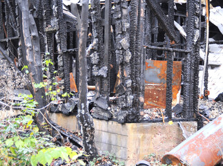 Closeup shot of an abandoned, burned ruin among nature