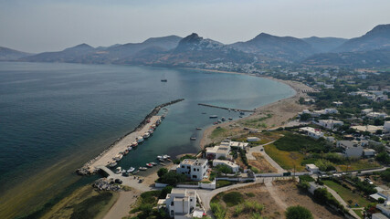 Aerial drone photo of small harbour of Molos a traditional boat safe anchorage near popular beach...