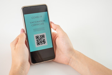 vaccination certificate with qr code,vaccine passport digital application of covid vaccine,hands with a smartphone