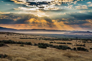 Incredible sunset. Mountains are lighted by sun rays. US 287 rd , Cameron, Montana, USA