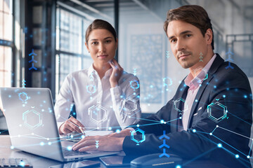 Businessman and businesswoman in formal wear working together to optimize business process by applying new technologies. Hi tech holograms over modern office background with panoramic windows