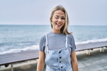 Young caucasian woman outdoors winking looking at the camera with sexy expression, cheerful and...