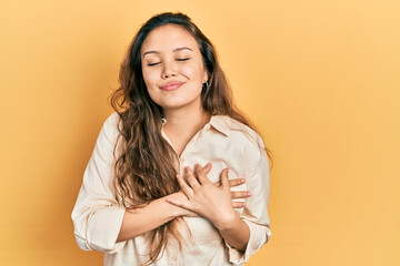 Young hispanic girl wearing casual clothes smiling with hands on chest, eyes closed with grateful gesture on face. health concept.