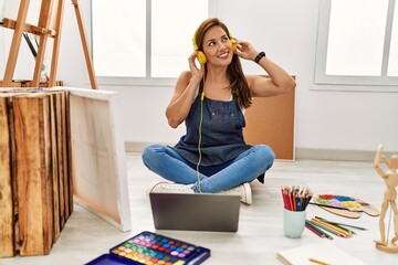 Young hispanic artist woman smiling happy drawing at art studio.