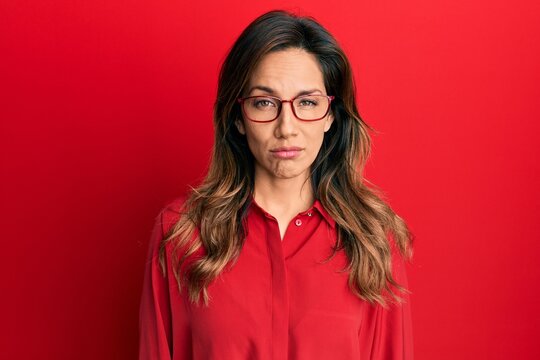 Young latin woman wearing casual clothes and glasses depressed and worry for distress, crying angry and afraid. sad expression.
