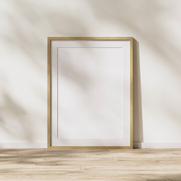 blank wooden frame with mat mock up, wooden poster frame on wooden floor with sunlight with leaves shadow on white wall, 3d rendering