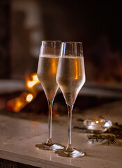 icy prosecco glasses on the background of the fireplace