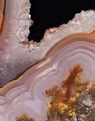 light orange agate slice with quartz crystals on black