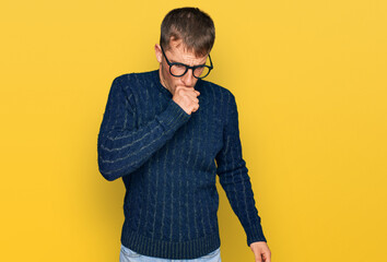 Young blond man wearing casual clothes and glasses feeling unwell and coughing as symptom for cold...