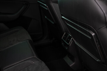 Car folding table inside modern car interior. Folding table on the back of the front seat.