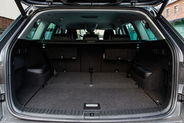 Huge, clean and empty car trunk in interior of a modern compact suv. Rear view of a SUV car with...