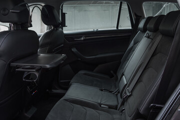 Modern SUV car inside. Leather black back passenger seats in modern luxury car. Comfortable leather seats.