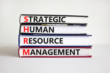 SHRM, strategic human resource management symbol. Words SHRM, strategic human resource management symbol on books on a beautiful white background. Business, SHRM concept. Copy space.