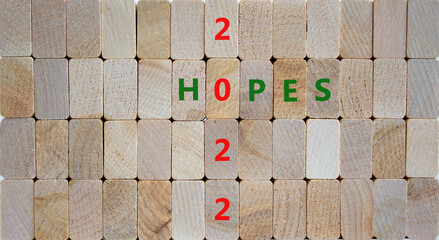 2022 hopes new year symbol. Wooden blocks with words 'Hopes 2022'. Beautiful wooden background,...