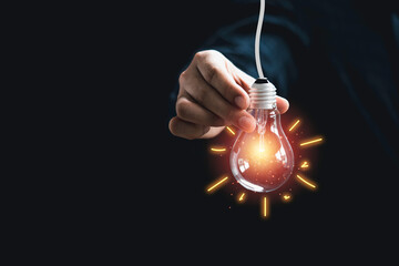 Businessman holding glowing lightbulb with illustration ray painting . It is creative thinking idea...