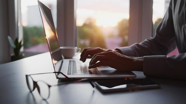 Businessman using laptop computer in office. Young man entrepreneur working at home. Online learning, internet marketing, business studying, working from home, education, web conferencing concept