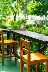 Fototapeta na wymiar empty wooden bar stool in garden