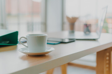 Fototapeta na wymiar white coffee cup on working table
