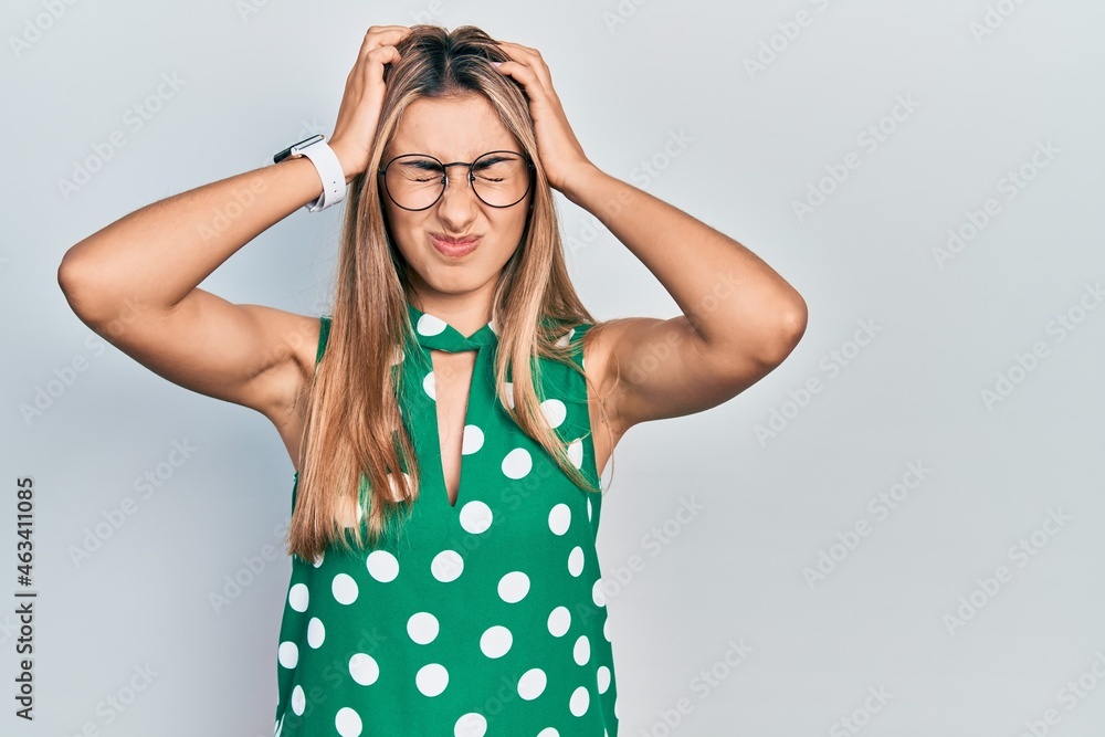 Poster beautiful hispanic woman wearing elegant shirt and glasses suffering from headache desperate and str