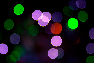 Colored blurred bokeh. abstract background of included festive garlands. colorful blur light bulbs