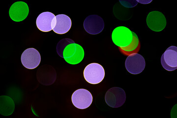 Colored blurred bokeh. abstract background of included festive garlands. colorful blur light bulbs