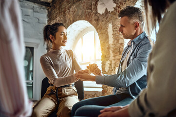 Diverse company members gather together to do team-building exercises. Woman and man at rehab...