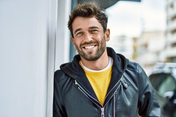 Handsome hispanic man with beard smiling happy outdoors