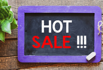 HOT SALE text on chalk board. Concept for business, time of discounts and promotions in stores and on the Internet.