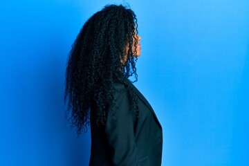 Middle age african american woman wearing business clothes looking to side, relax profile pose with natural face with confident smile.