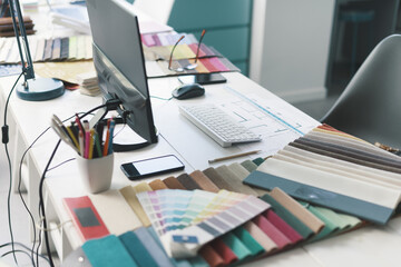 Interior designer work desktop with fabric swatches