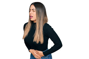 Young hispanic woman wearing casual clothes with hand on stomach because nausea, painful disease feeling unwell. ache concept.