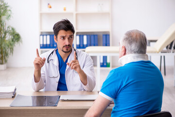Old neck injured male patient visiting young male doctor
