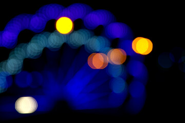 Fototapeta premium Colored blurred bokeh. abstract background of included festive garlands. colorful blur light bulbs