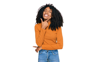 Young african american girl wearing casual clothes looking confident at the camera smiling with crossed arms and hand raised on chin. thinking positive.