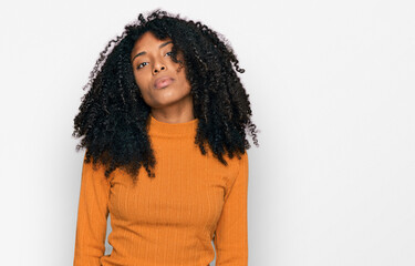 Young african american girl wearing casual clothes relaxed with serious expression on face. simple and natural looking at the camera.