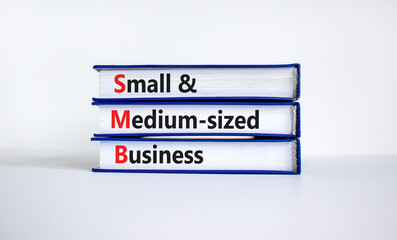 SMB small and medium-sized business symbol. Words SMB small and medium-sized business on books on a beautiful white background. Business and SMB small and medium-sized business concept. Copy space.