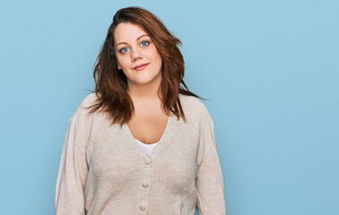Obraz premium Young plus size woman wearing casual clothes relaxed with serious expression on face. simple and natural looking at the camera.