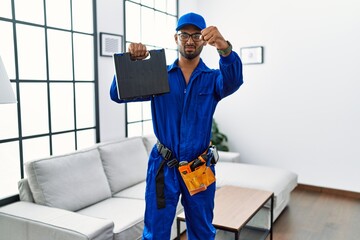 Young indian technician holding toolbox and screwdriver at house annoyed and frustrated shouting with anger, yelling crazy with anger and hand raised