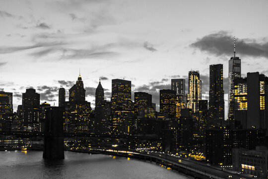 Fototapeta Yellow lights in black and white skyline scene of Lower Manhattan buildings in New York City