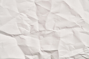 Fototapeta premium White crumpled paper texture with wrinkles. Damaged and torn sheet